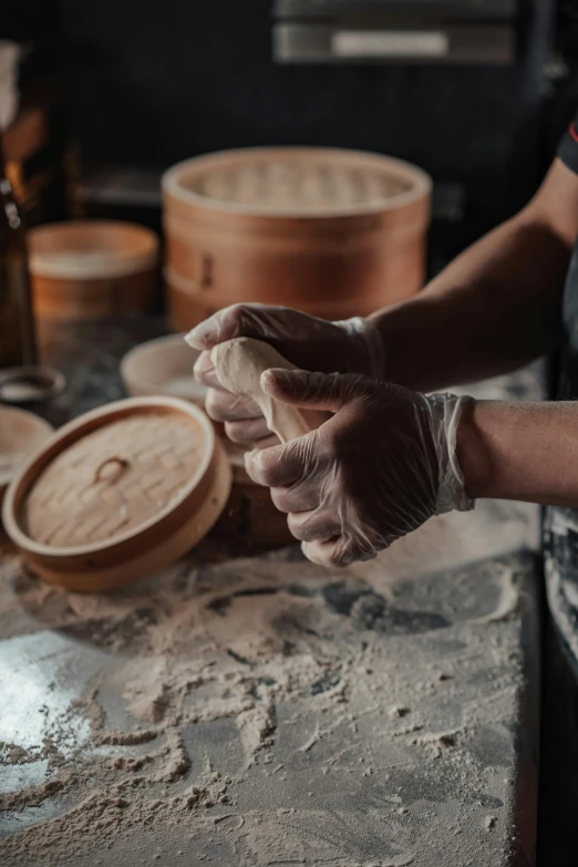 the gloved hand of a cook preparing soing