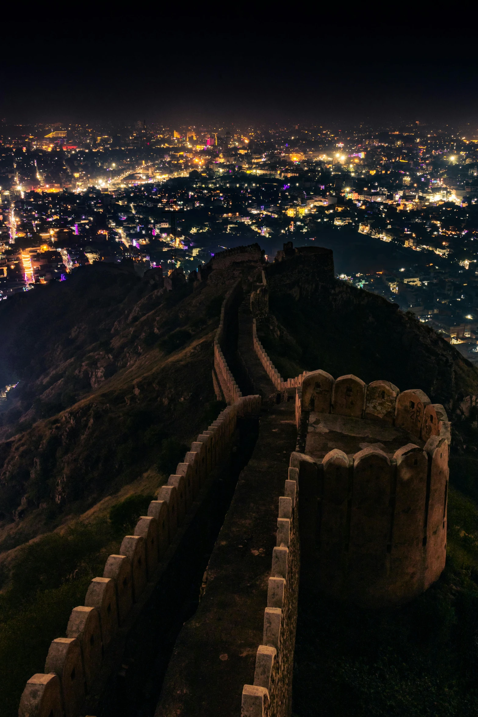 a wall with some lights on in the background