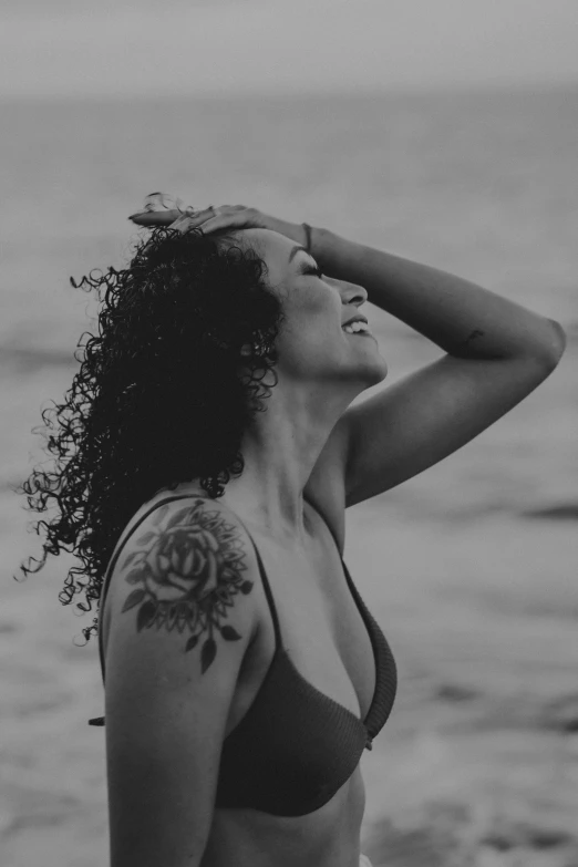 a woman wearing a bikini posing on a beach