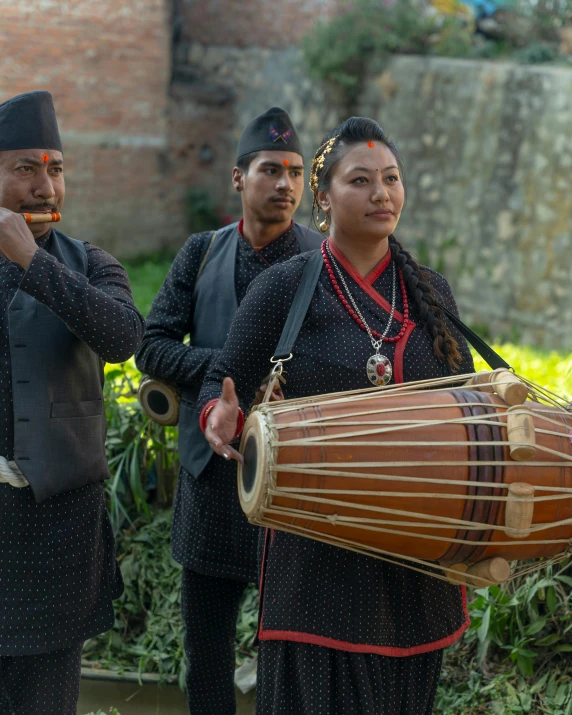 some people are holding a large musical instrument