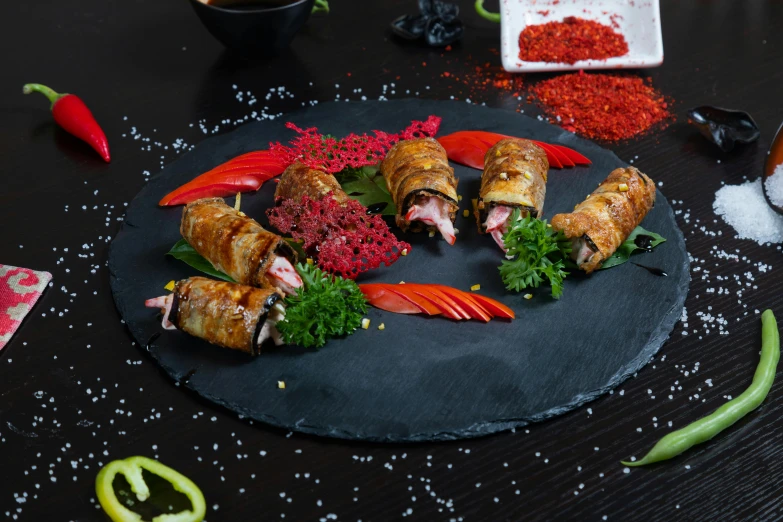 an image of some food items on a black plate