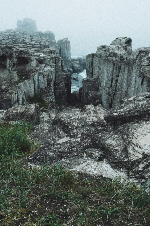 a view from an overlook with a grassy area in the foreground