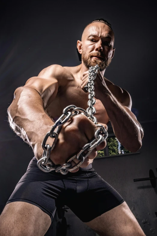 a man pulling a chain with his hands