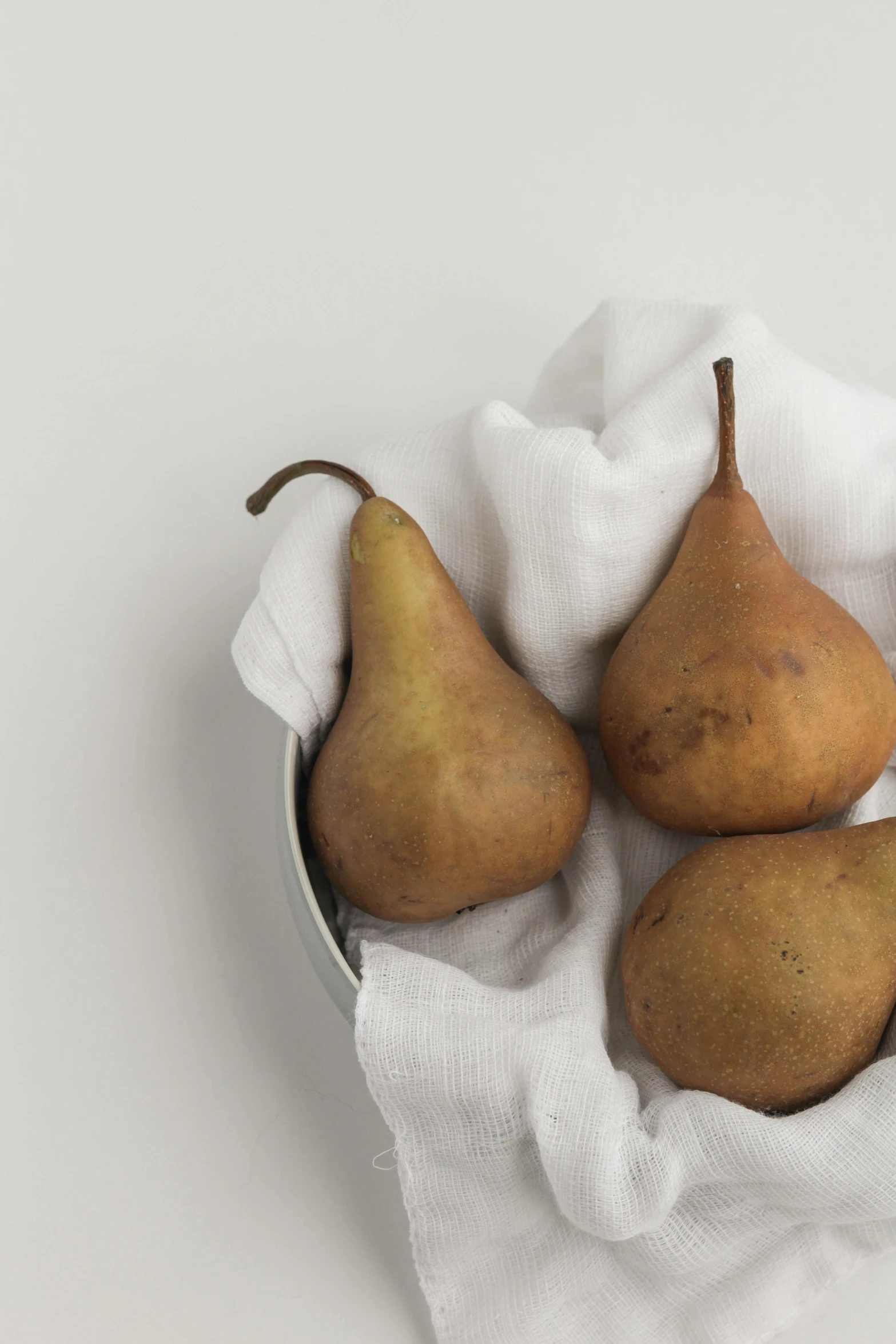 three pieces of fruit, one of which has been shaped into pears