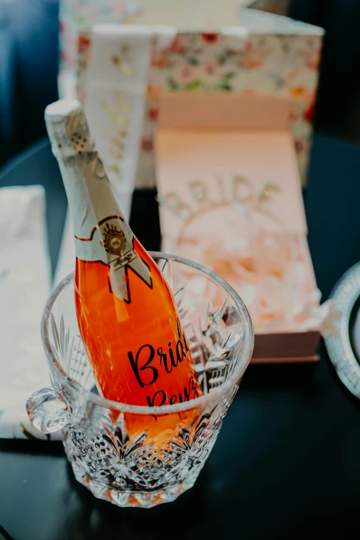 an old champagne bottle sits in a glass cup