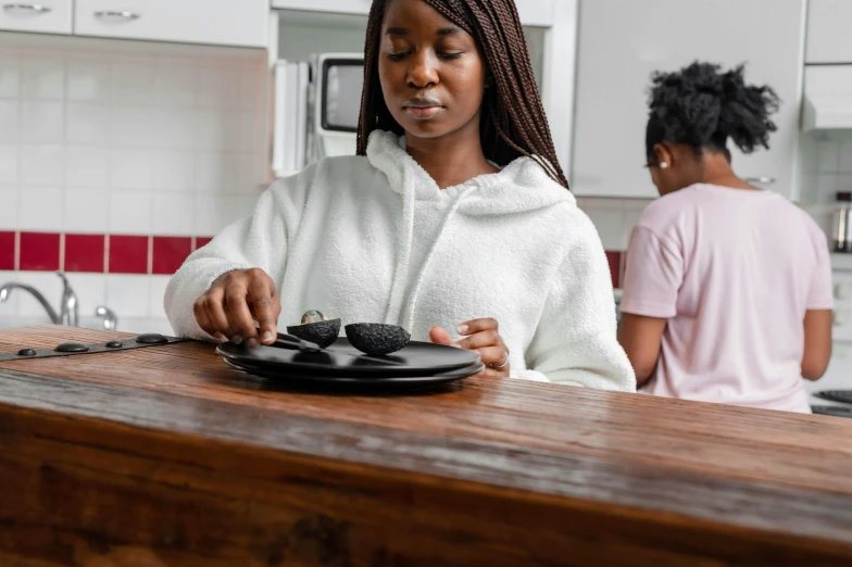 a woman and a boy are in the kitchen