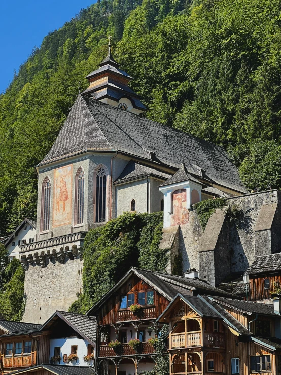 an old house is nestled on the side of a hill