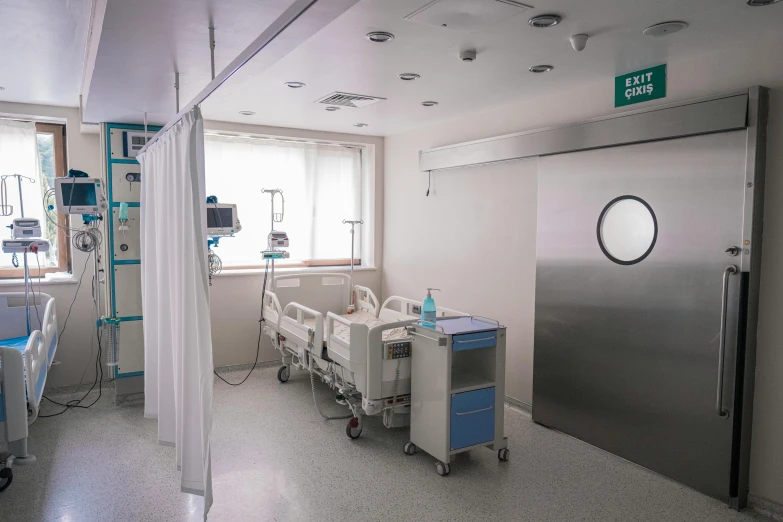 a hospital room with machines in the room