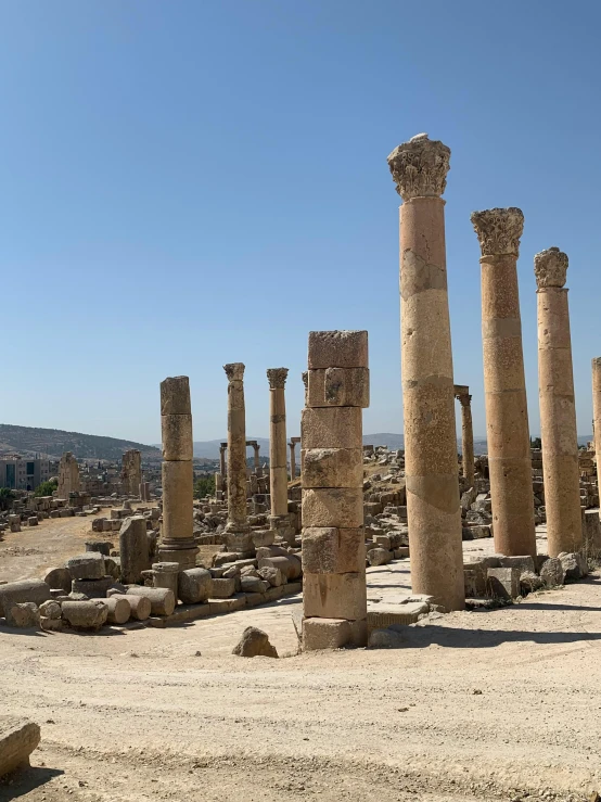 ruins, pillars and trees on the horizon in an ancient city