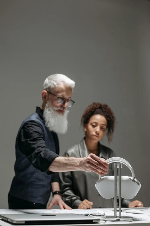 a man standing over a sink next to a woman