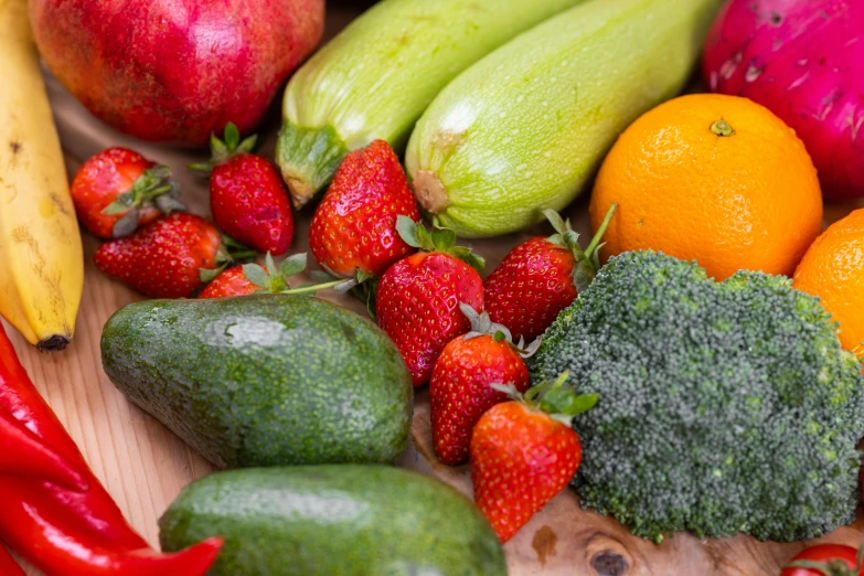 fresh fruit and vegetables that are on top of a wooden table