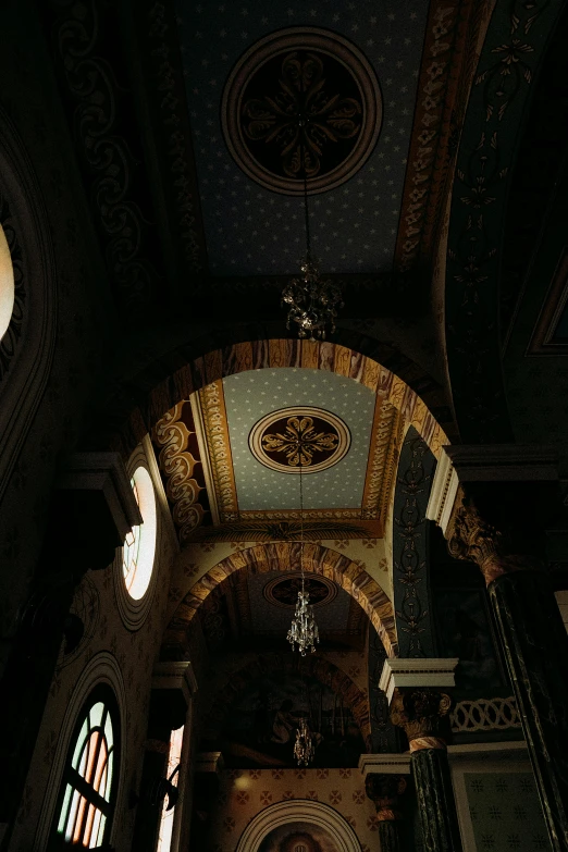 a cathedral with stained glass windows and chandelier