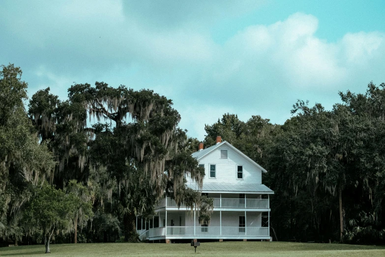 a white house with trees in the background