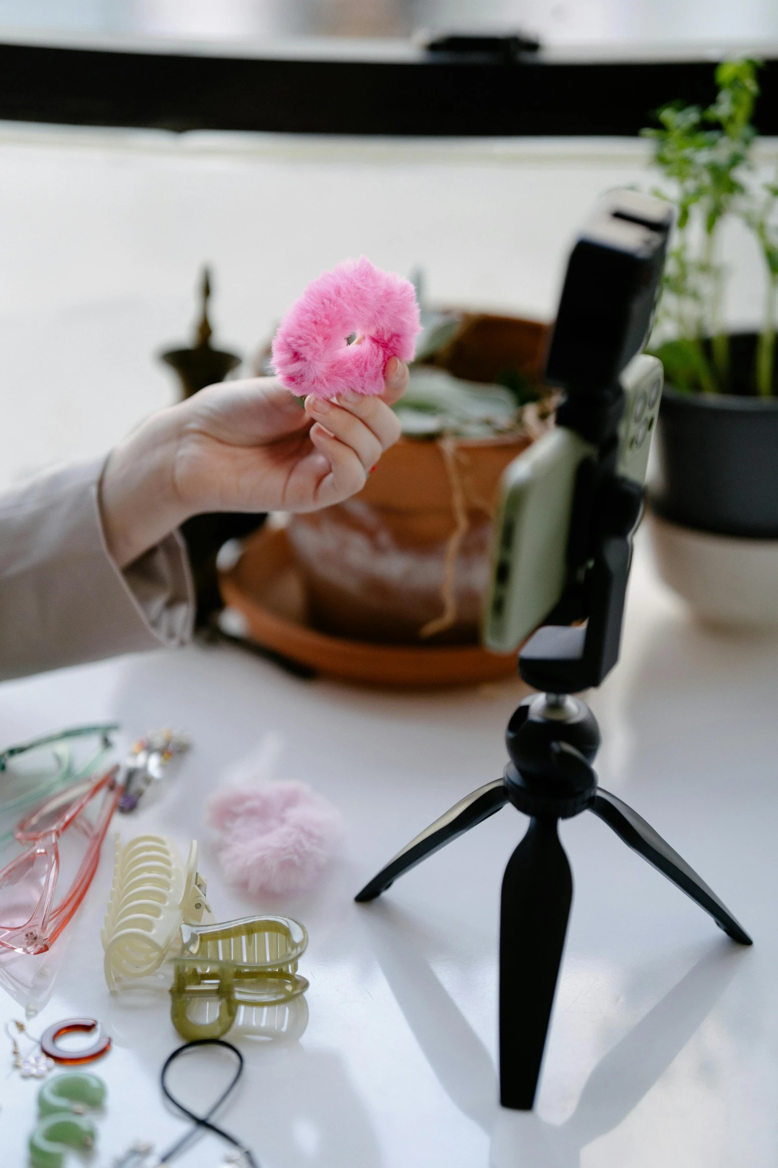 a person is holding a pink ball and a camera