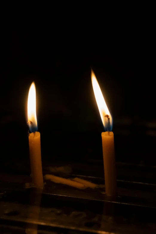 two candles in the dark lit with light