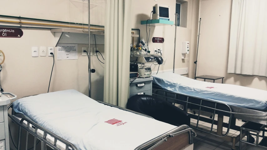 two empty beds in a medical room