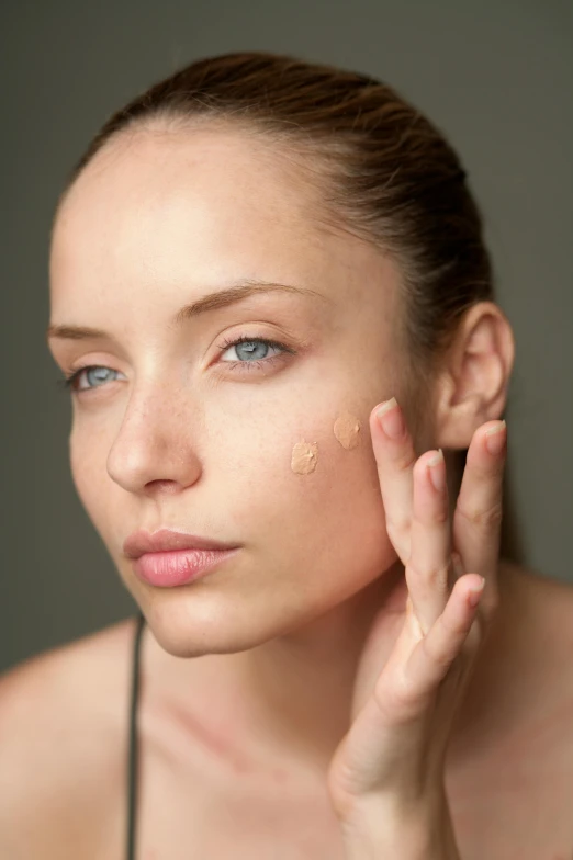 a woman holding up her hand while she looks down