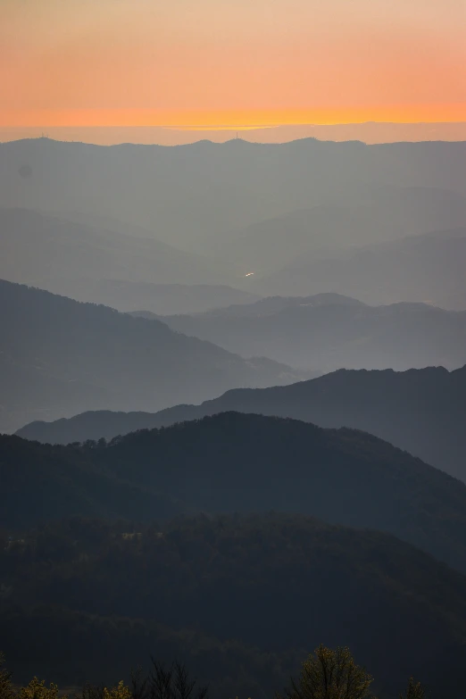 a view of the hills from a distance with sunset