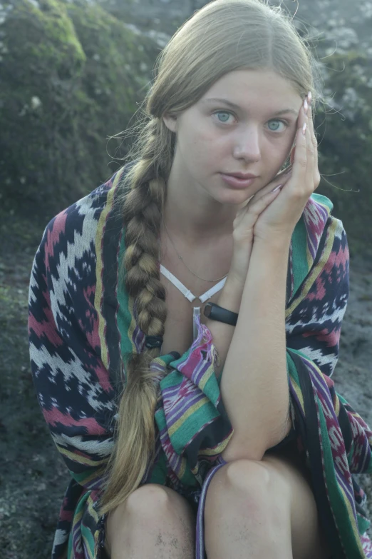 the girl is sitting in front of the camera