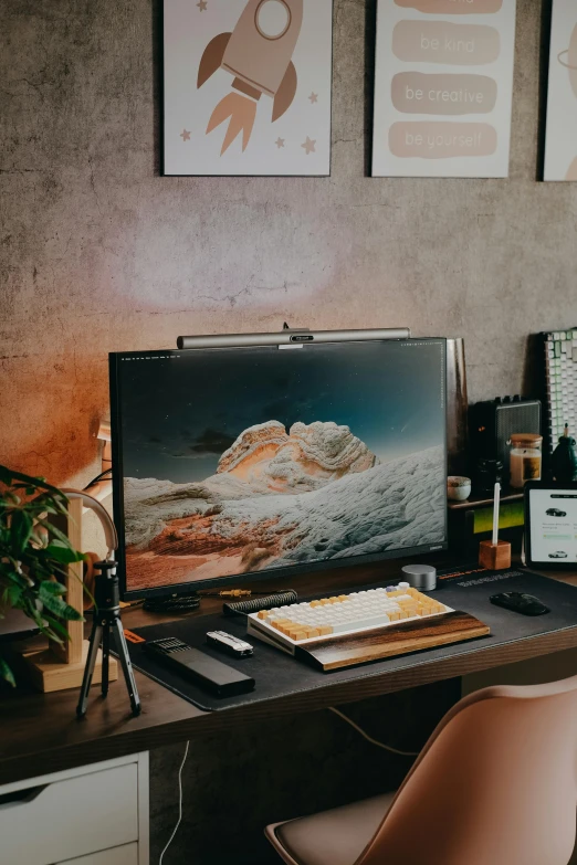 a computer desk topped with a laptop computer next to a monitor