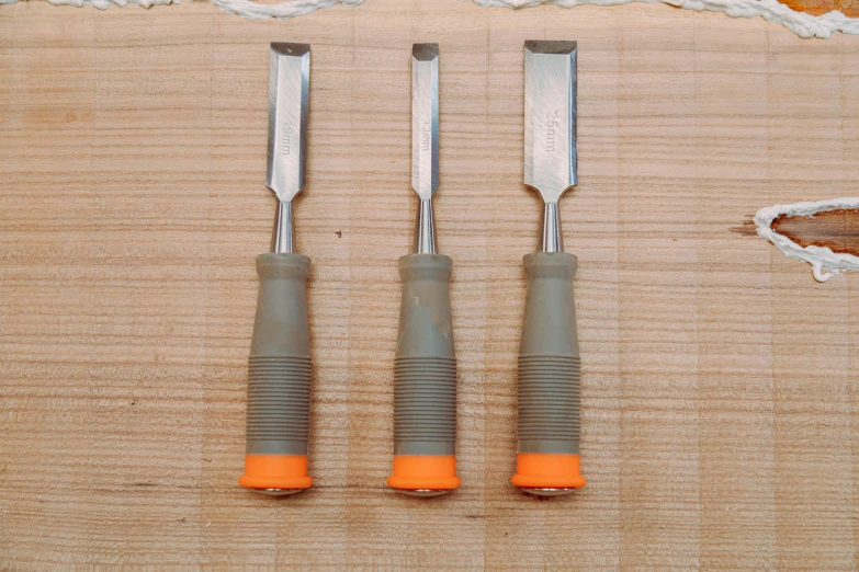 a close up of three different tools on a table