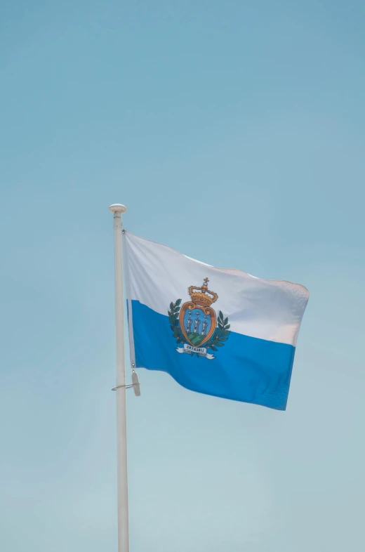 flag flying in the air under a clear blue sky