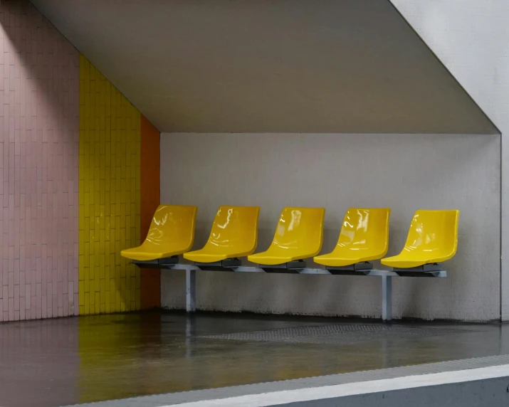 four chairs lined up in a line on the floor