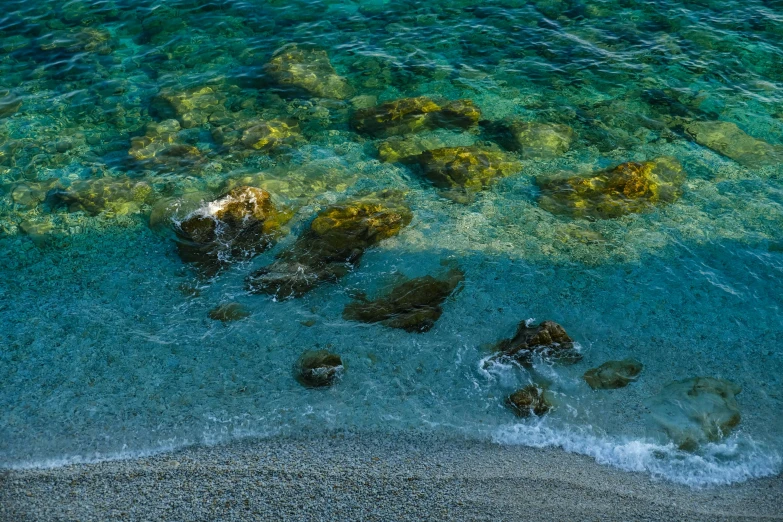 an ocean shore with pebbles and water