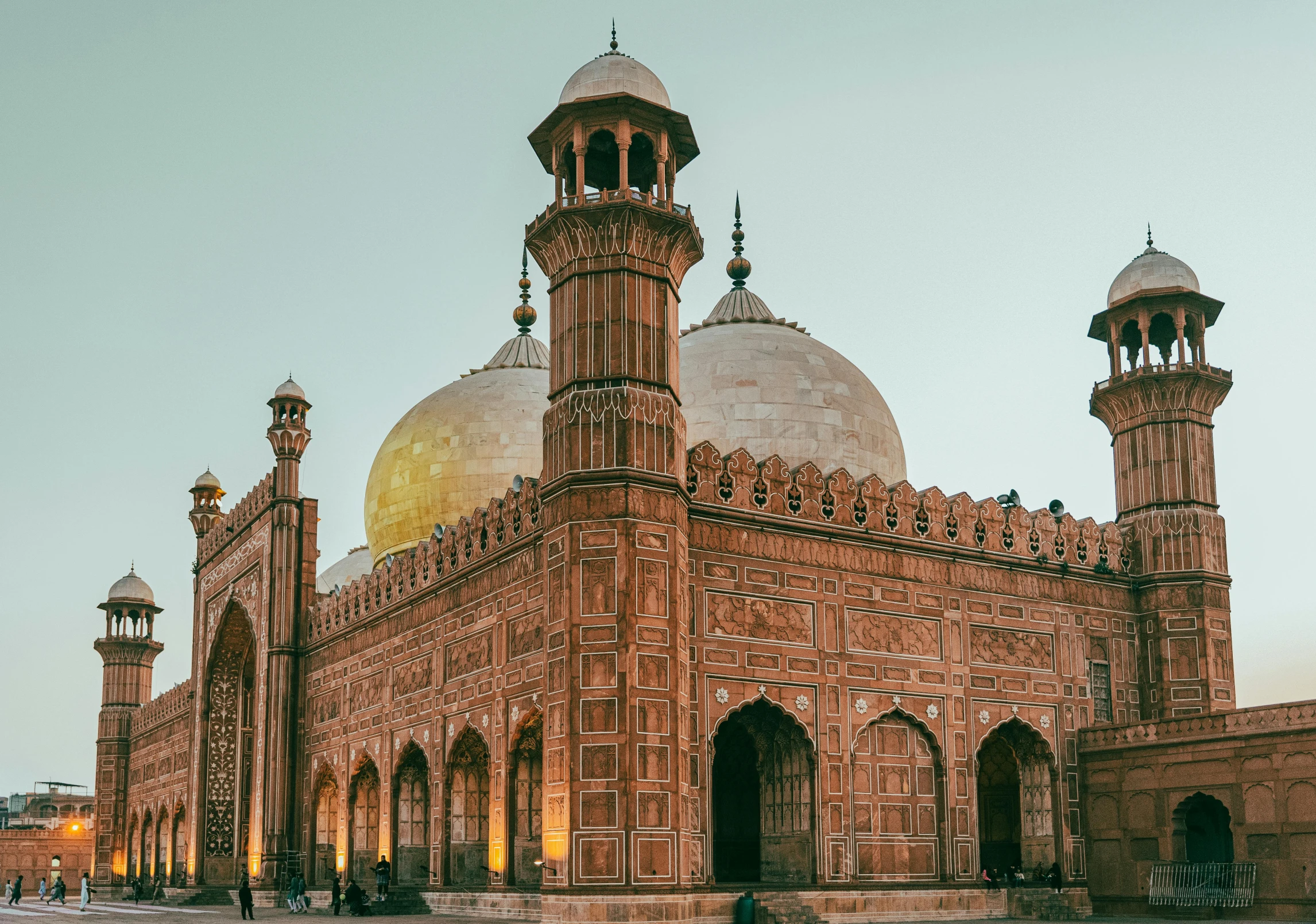 a large building with tall towers with arches