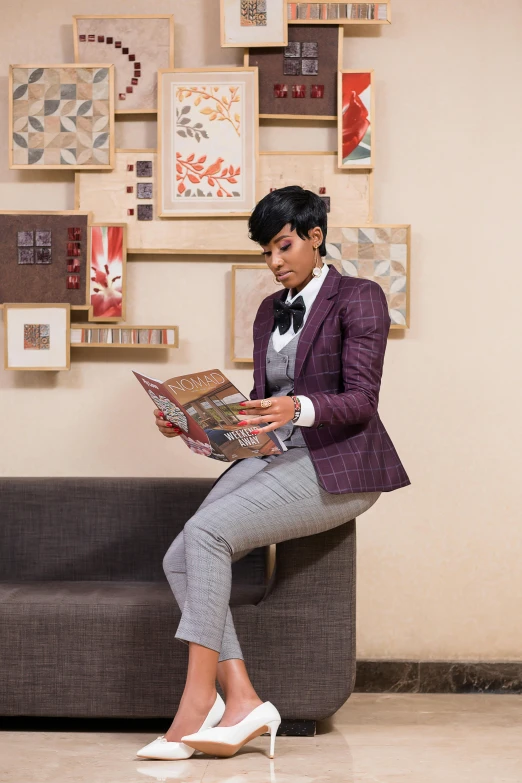 woman in evening clothes reading book while sitting on a bench