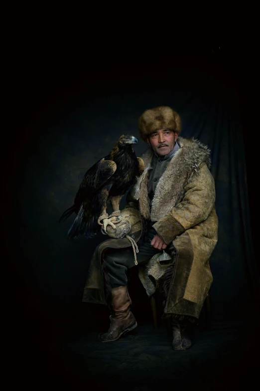an image of man with an eagle and black background