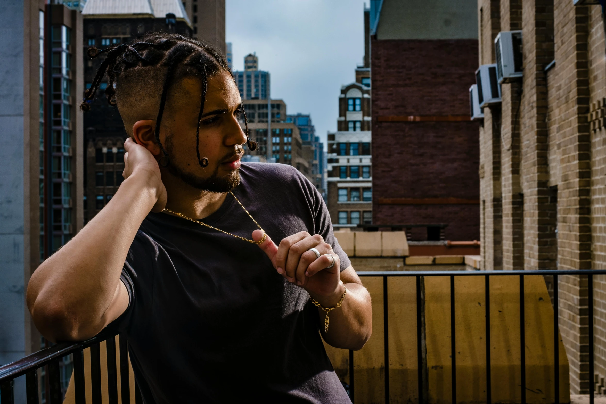 a person sitting on a balcony holding his hand to their ear