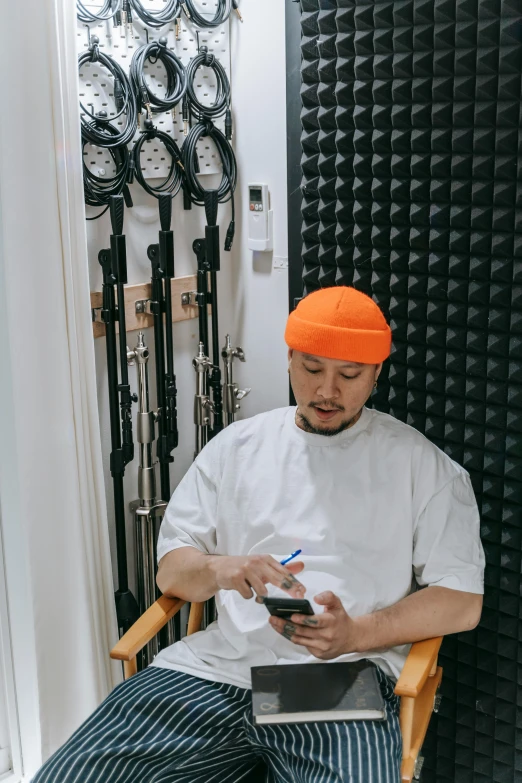 a man sits in a chair holding a phone