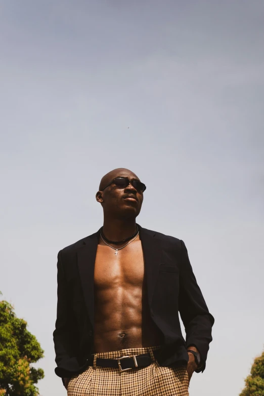 a man standing on top of a grass covered field