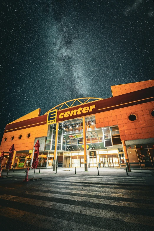 the entrance to an outdoor shopping center under the stars