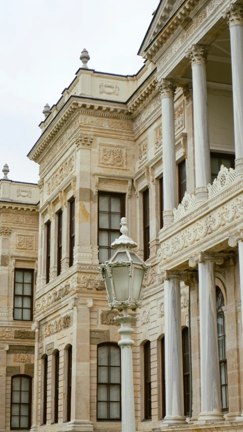 the street light is on next to the building