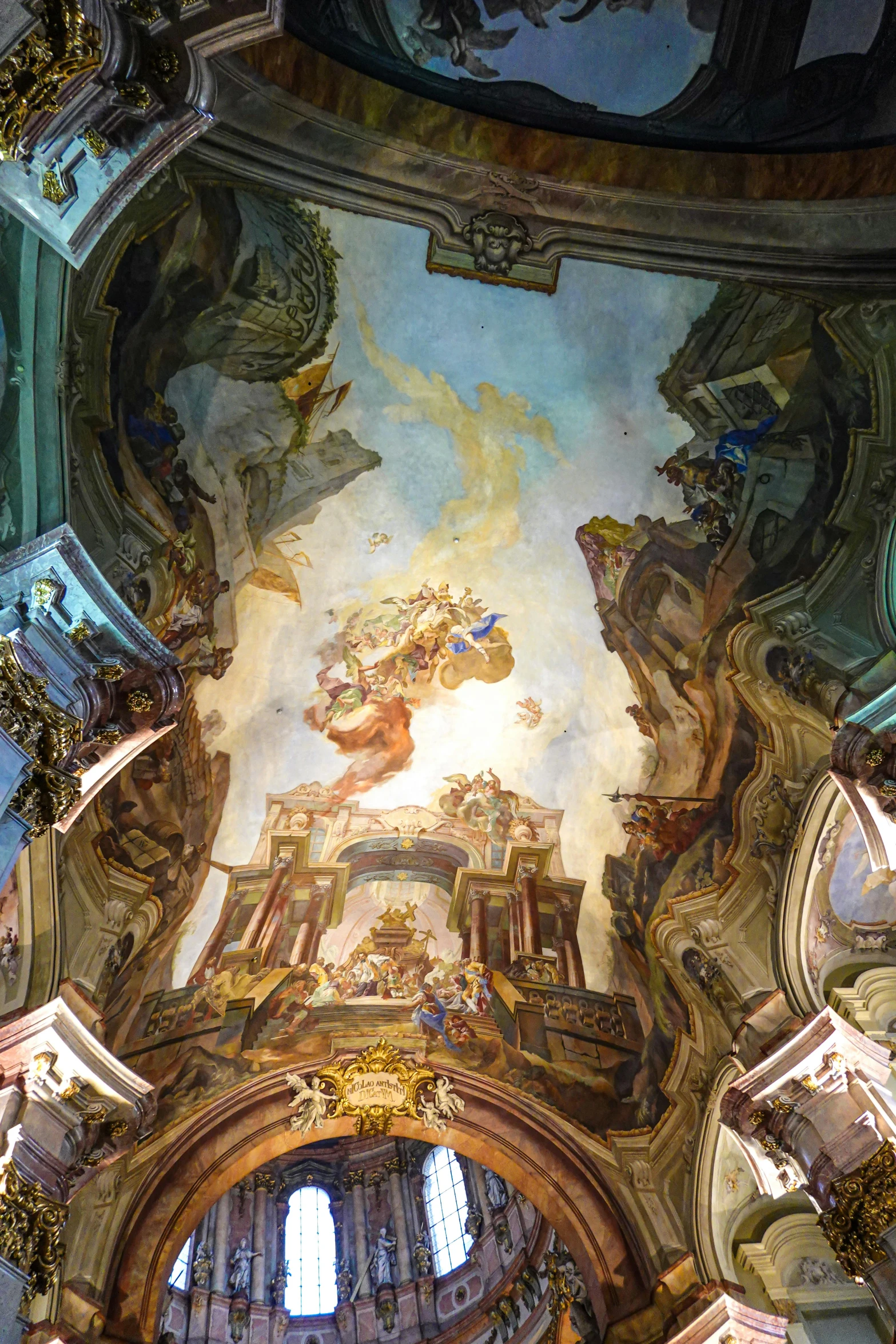 a ceiling with a painting above it in a room