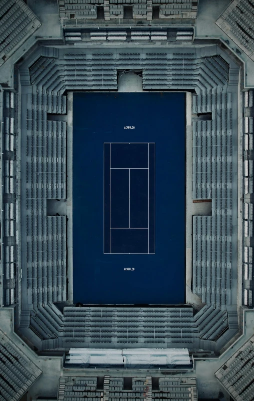 a stadium filled with empty seats and a tennis court