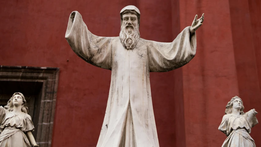 the statues of jesus and mary outside of a red church