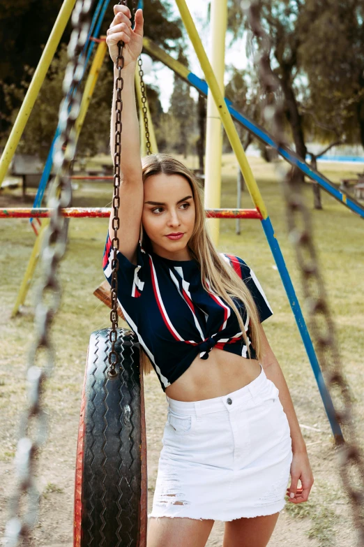 woman hanging upside down on playground equipment and smiling