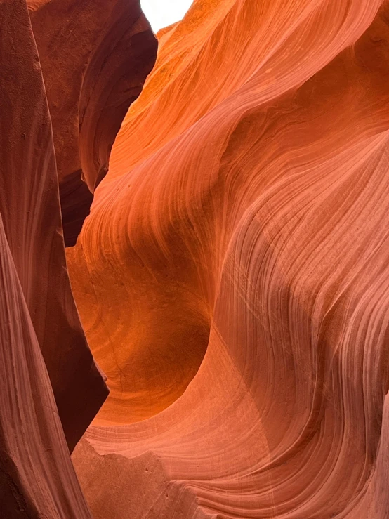 the red sand is shaped like waves in a canyon