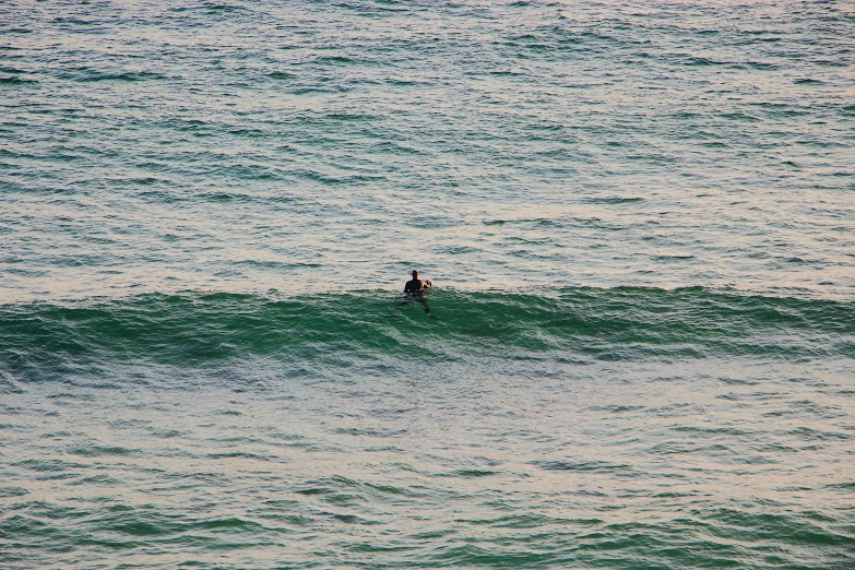 a person riding on top of a wave in the ocean