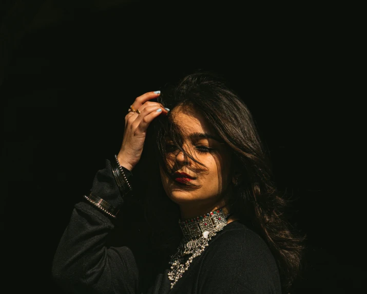 a woman is holding a celet over her head