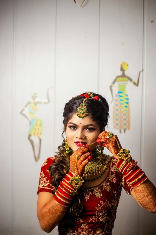 an indian girl poses for a po in traditional attire