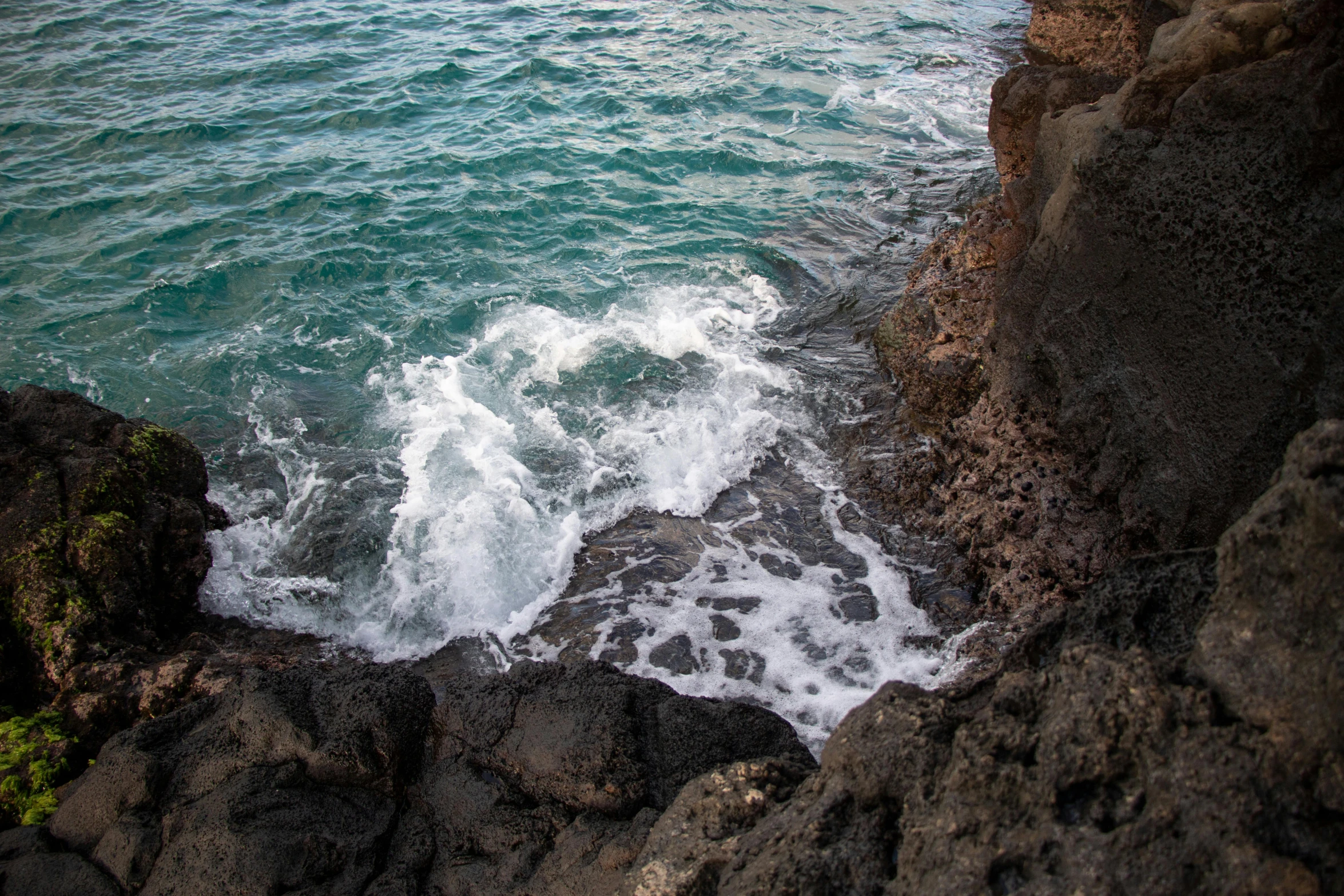 some very nice water by the side of a cliff