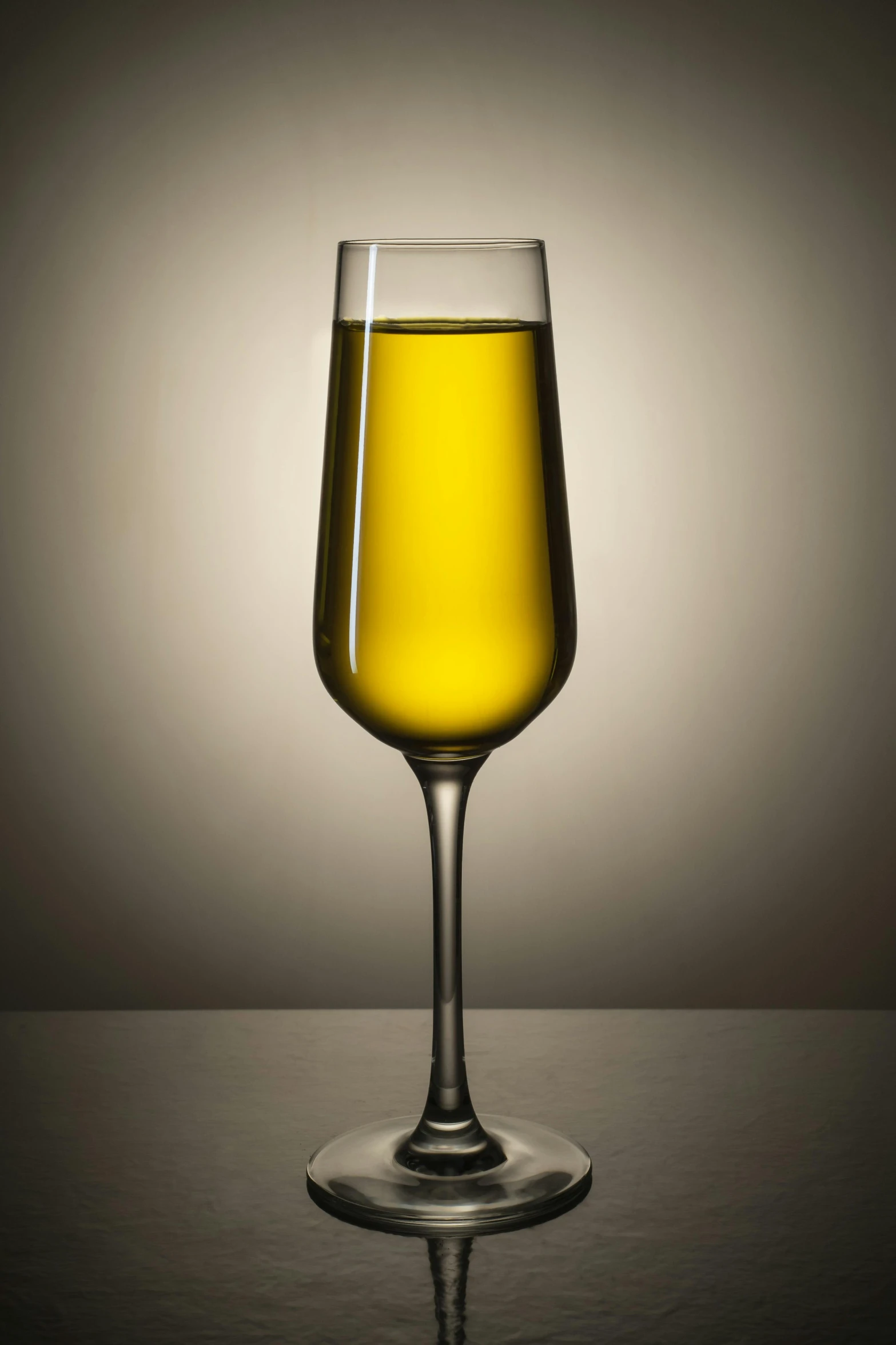 an empty glass with yellow liquid in the middle