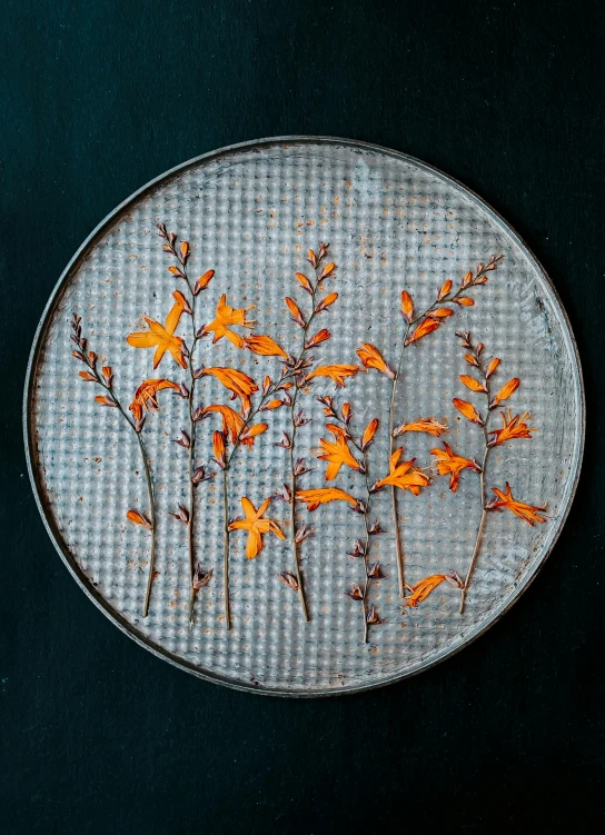 there is a plate that has orange flowers on it