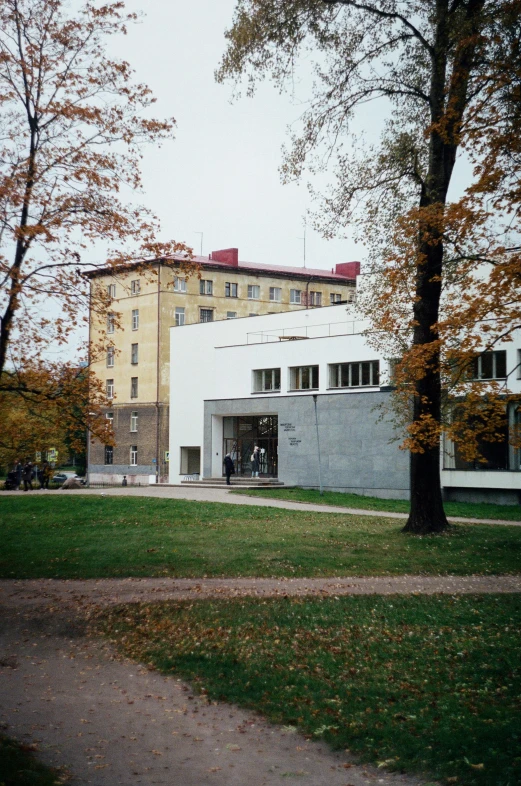 a couple of people standing in front of a white building