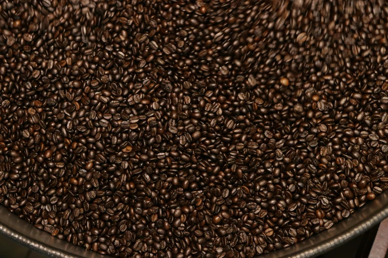 a large pail filled with lots of coffee beans