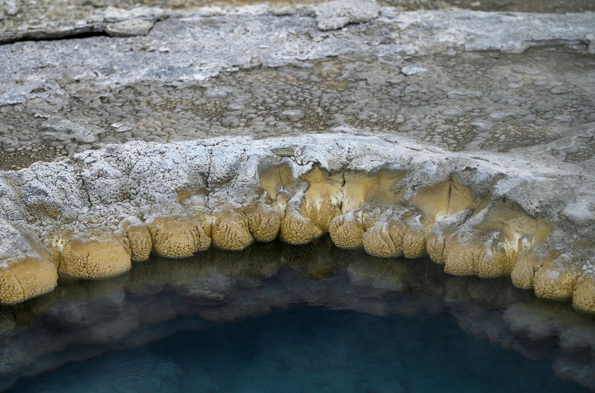 a hole in the stone with water running inside